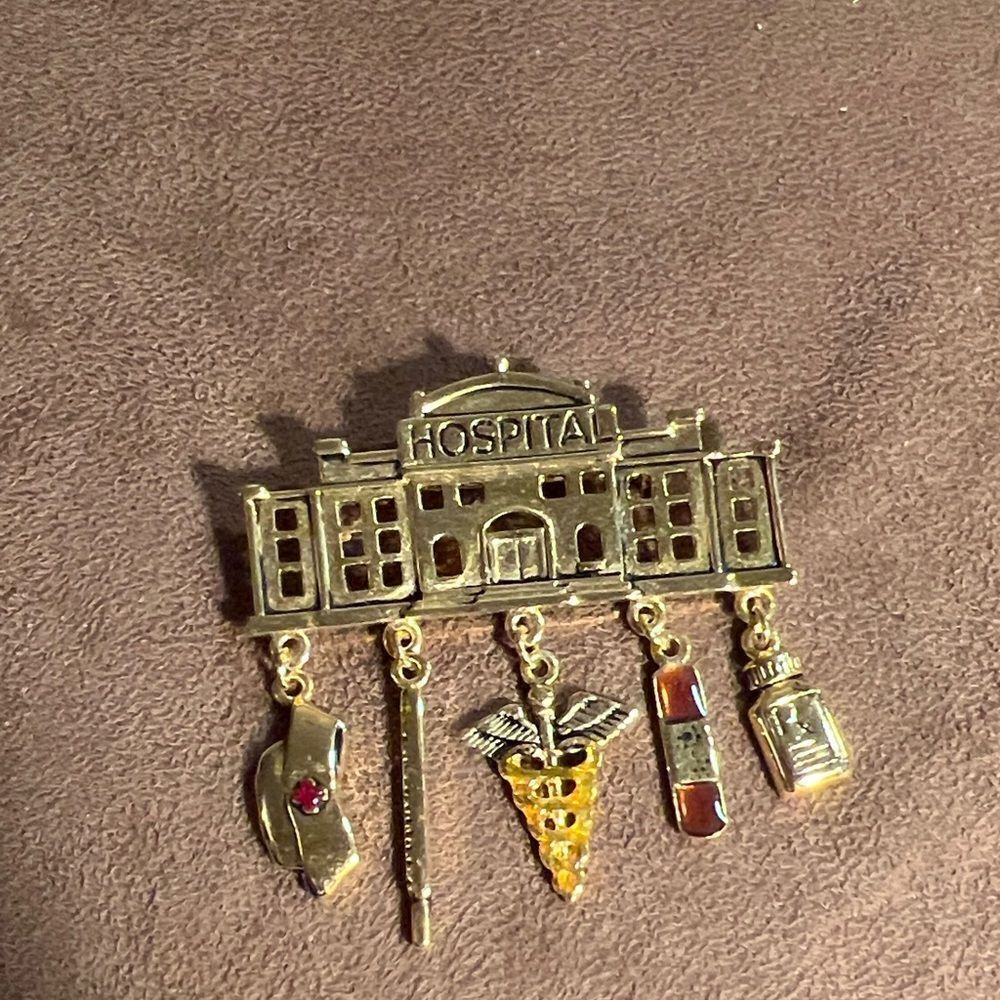 Faux gold hospital brooch.